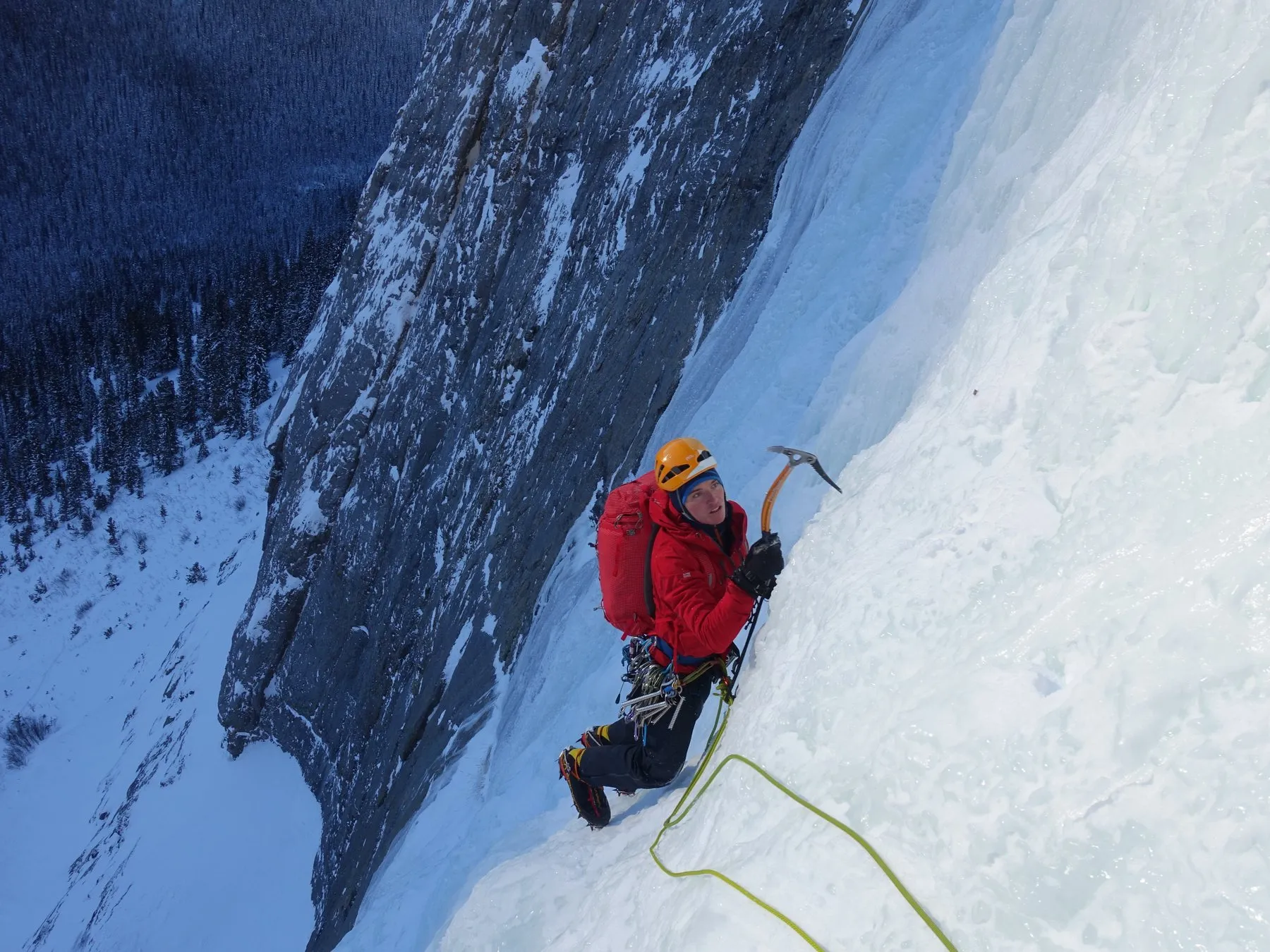 Alastair leading a steep ice and mixed pitch, ropes trailing