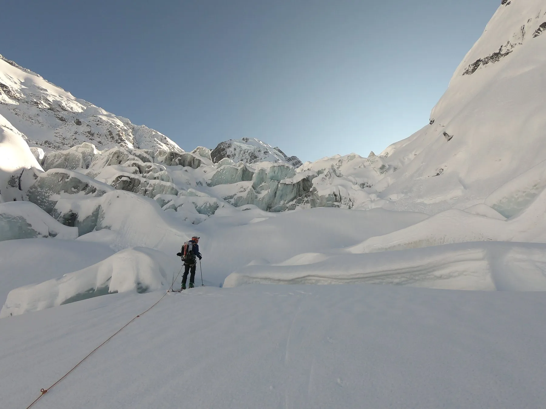 A lone figure walking through an icefall