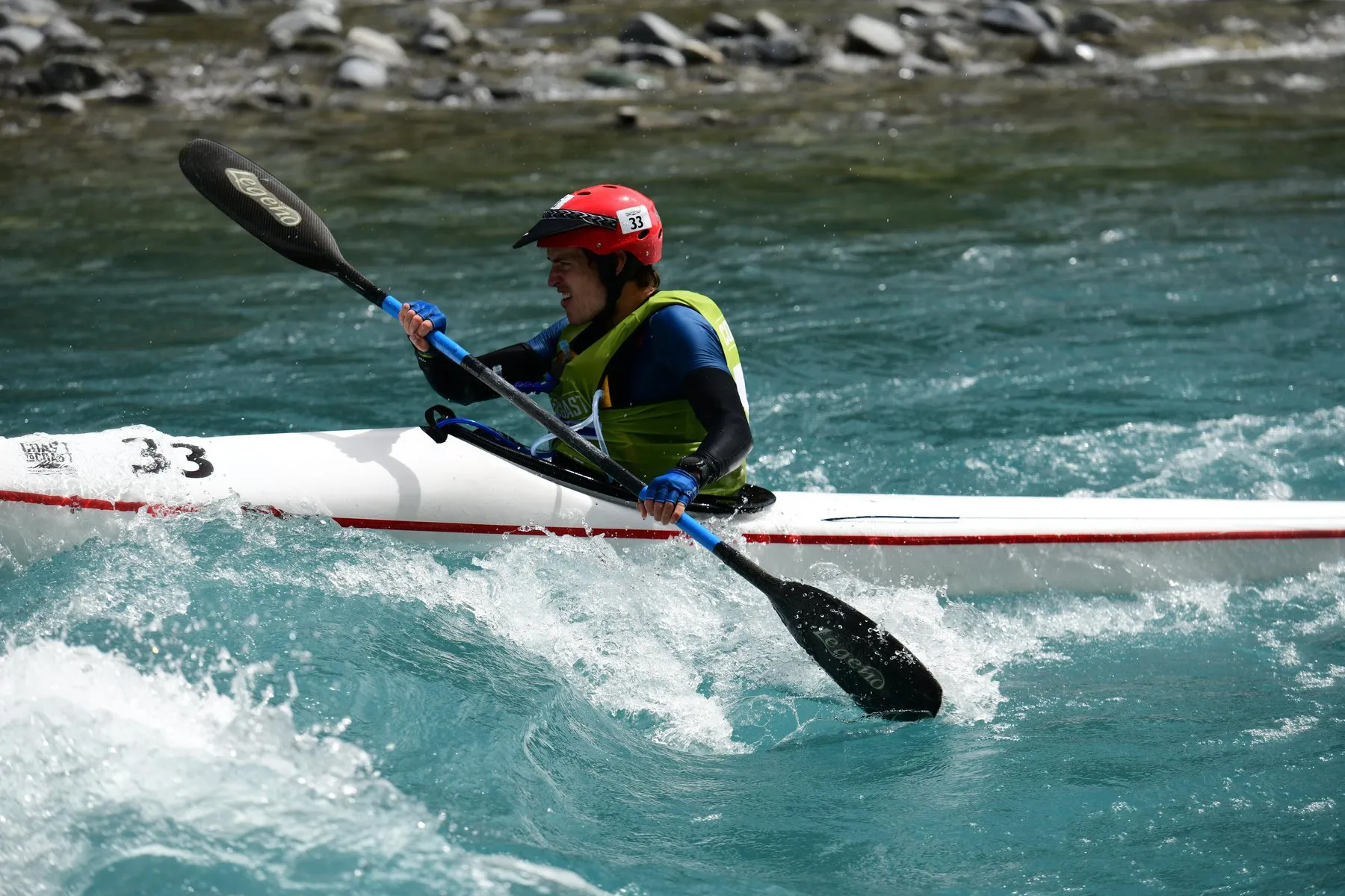 Alastair paddling a kayak through a rapid