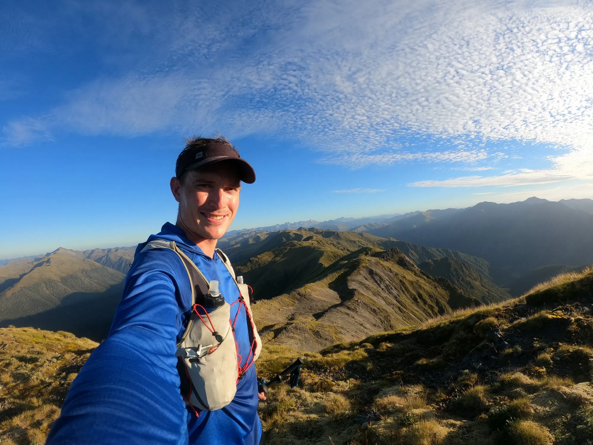 Alastair running on a tussock ridge with a soft flask in his vest